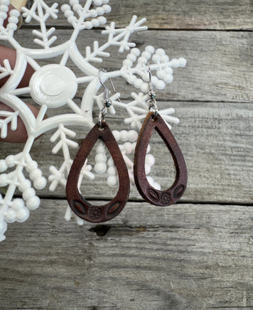 Small hand-stamped leather teardrop earrings with floral and rope design, chocolate brown with sterling silver hooks, handmade by Cherokee Rose Custom Leather in Texas.