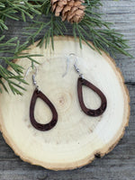 Small hand-stamped leather teardrop earrings with floral and rope design, chocolate brown with sterling silver hooks, handmade by Cherokee Rose Custom Leather in Texas.