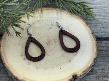 Small hand-stamped leather teardrop earrings with floral and rope design, chocolate brown with sterling silver hooks, handmade by Cherokee Rose Custom Leather in Texas.