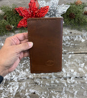 Handmade leather Field Notes cover in smooth oil-tanned brown leather with black stitching, crafted by Cherokee Rose Custom Leather in East Texas.