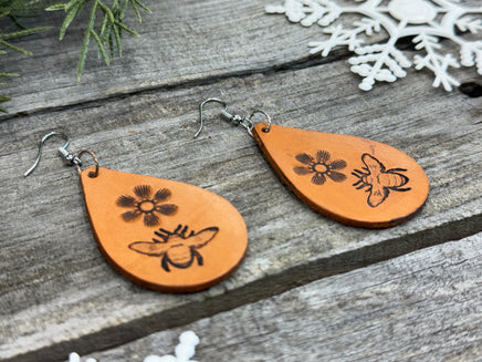 Hand-stamped leather earrings with honey bee and flower design, sterling silver ear wires, handmade by Cherokee Rose Custom Leather in East Texas.