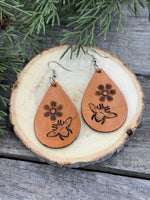 Hand-stamped leather earrings with honey bee and flower design, sterling silver ear wires, handmade by Cherokee Rose Custom Leather in East Texas.