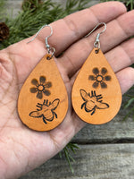 Hand-stamped leather earrings with honey bee and flower design, sterling silver ear wires, handmade by Cherokee Rose Custom Leather in East Texas.