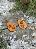 Hand-stamped leather earrings with honey bee and flower design, sterling silver ear wires, handmade by Cherokee Rose Custom Leather in East Texas.