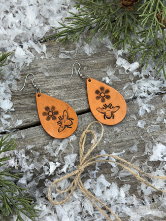 Hand-stamped leather earrings with honey bee and flower design, sterling silver ear wires, handmade by Cherokee Rose Custom Leather in East Texas.