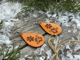 Hand-stamped leather earrings with honey bee and flower design, sterling silver ear wires, handmade by Cherokee Rose Custom Leather in East Texas.