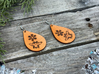 Hand-stamped leather earrings with honey bee and flower design, sterling silver ear wires, handmade by Cherokee Rose Custom Leather in East Texas.