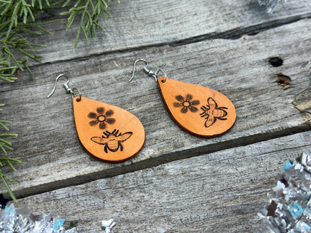 Hand-stamped leather earrings with honey bee and flower design, sterling silver ear wires, handmade by Cherokee Rose Custom Leather in East Texas.