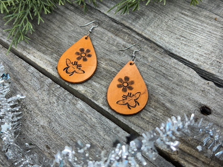 Hand-stamped leather earrings with honey bee and flower design, sterling silver ear wires, handmade by Cherokee Rose Custom Leather in East Texas.