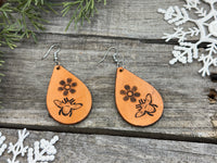 Hand-stamped leather earrings with honey bee and flower design, sterling silver ear wires, handmade by Cherokee Rose Custom Leather in East Texas.