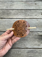 Intricately hand stamped Zia Sun leather hair barrette with bamboo hair stick.