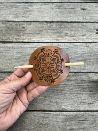 Intricately hand stamped Zia Sun leather hair barrette with bamboo hair stick.