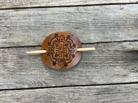 Intricately hand stamped Zia Sun leather hair barrette with bamboo hair stick.