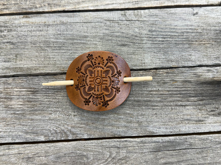 Intricately hand stamped Zia Sun leather hair barrette with bamboo hair stick.