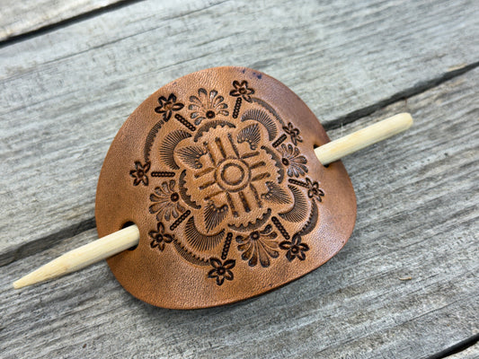 Intricately hand stamped Zia Sun leather hair barrette with bamboo hair stick.