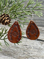 Medium brown teardrop leather earrings with Thunderbird and arrow stamped design, sterling silver ear wires, handmade by Cherokee Rose Custom Leather in East Texas.