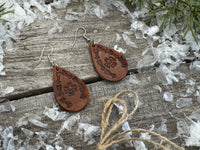 Medium brown teardrop leather earrings with Thunderbird and arrow stamped design, sterling silver ear wires, handmade by Cherokee Rose Custom Leather in East Texas.