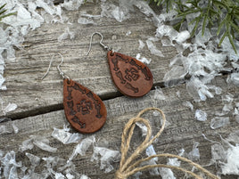 Medium brown teardrop leather earrings with Thunderbird and arrow stamped design, sterling silver ear wires, handmade by Cherokee Rose Custom Leather in East Texas.