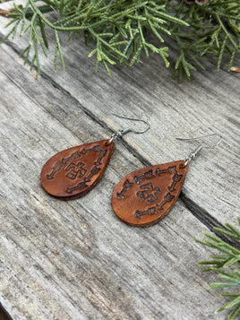Medium brown teardrop leather earrings with Thunderbird and arrow stamped design, sterling silver ear wires, handmade by Cherokee Rose Custom Leather in East Texas.