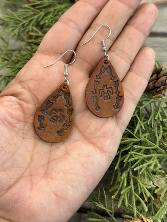 Medium brown teardrop leather earrings with Thunderbird and arrow stamped design, sterling silver ear wires, handmade by Cherokee Rose Custom Leather in East Texas.