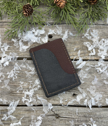 Two-tone handmade leather card wallet in reddish oil-tanned and black pigskin leather, stitched with brown waxed thread by Cherokee Rose Custom Leather.