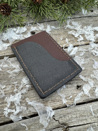 Two-tone handmade leather card wallet in reddish oil-tanned and black pigskin leather, stitched with brown waxed thread by Cherokee Rose Custom Leather.