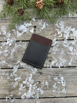 Two-tone handmade leather card wallet in reddish oil-tanned and black pigskin leather, stitched with brown waxed thread by Cherokee Rose Custom Leather.
