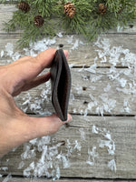 Two-tone handmade leather card wallet in reddish oil-tanned and black pigskin leather, stitched with brown waxed thread by Cherokee Rose Custom Leather.