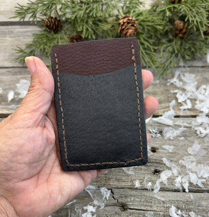 Two-tone handmade leather card wallet in reddish oil-tanned and black pigskin leather, stitched with brown waxed thread by Cherokee Rose Custom Leather.