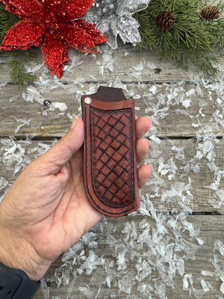 Handmade mahogany red leather knife sheath with hand-stamped basketweave design, vertical right-side carry, by Cherokee Rose Custom Leather.