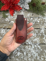 Handmade mahogany red leather knife sheath with hand-stamped basketweave design, vertical right-side carry, by Cherokee Rose Custom Leather.