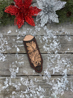 Hand tooled leather cast iron skillet handle cover in chocolate brown with carved leaf design and red stitching, handmade by Cherokee Rose Custom Leather in East Texas.