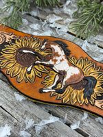 Wide hand-painted leather cuff bracelet with wild paint pony, sunflowers, and antique brass snaps, handmade by Cherokee Rose Custom Leather in East Texas.
