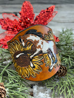 Wide hand-painted leather cuff bracelet with wild paint pony, sunflowers, and antique brass snaps, handmade by Cherokee Rose Custom Leather in East Texas.